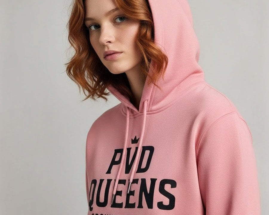 Person wearing a pink hoodie with text on a plain background