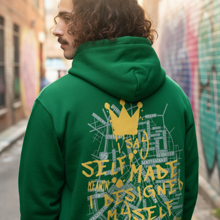 Person wearing a green hoodie with yellow text and graphics in an urban setting